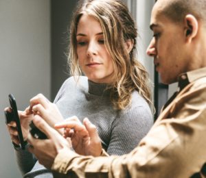 Picture of two people looking at a phone