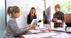 Professionals web developers team working together for mobile application software design project.