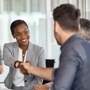 Lady shaking hands with a man