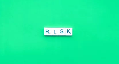 Picture of the letters risk spelled out with scrablle blocks