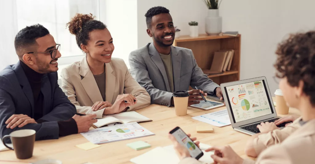 Project Management team working together at a desk. How to create a core culture for your team.